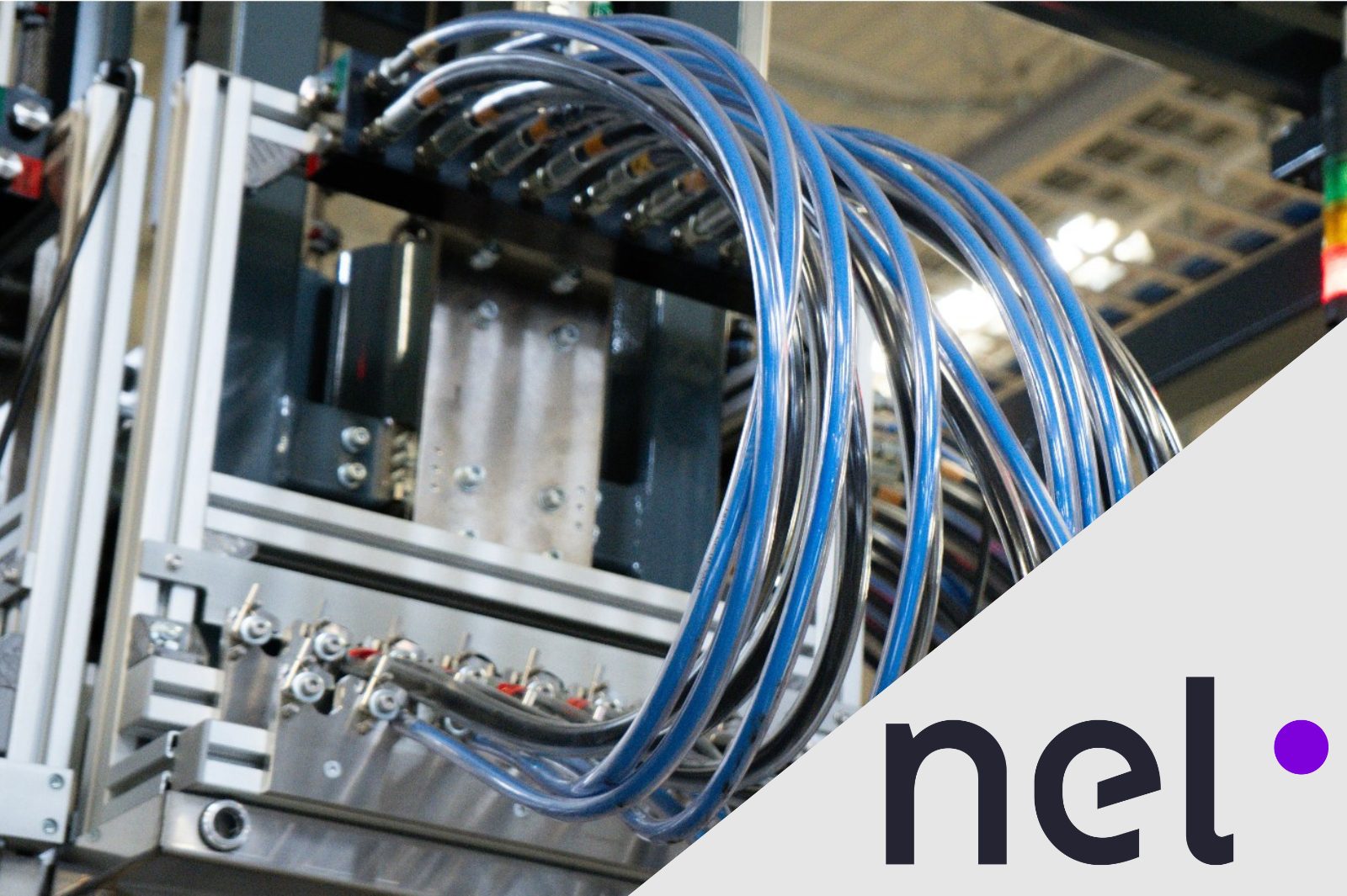 Nel logo is displayed with a MC250 containerized PEM electrolyser. The electrolyser is a silver machine with connecting wires in tubes.
