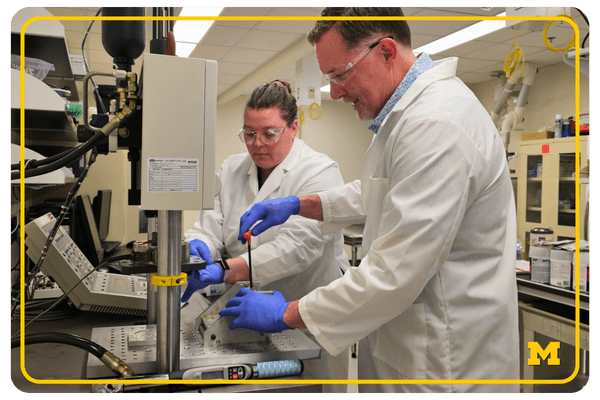 photo of Karl Jepsen working with another lab staff member in a lab