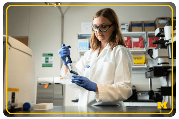 photo of Nadja Kramer working in her lab, pipetting 