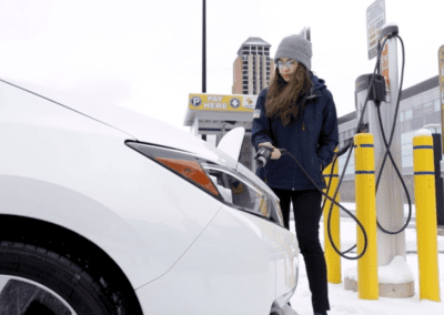 Engineering student Chloe Acosta plugs in an EV for charging in snowy weather on the University of Michigan’s North Campus. EV charging becomes less efficient in colder weather, but a new strategy for manufacturing battery electrodes could enable charging in 10 minutes in temperatures as cold as -10C. Image credit: Marcin Szczepanski, Michigan Engineering