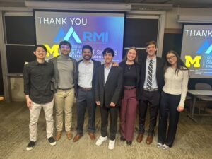 A group of students and faculty smile
