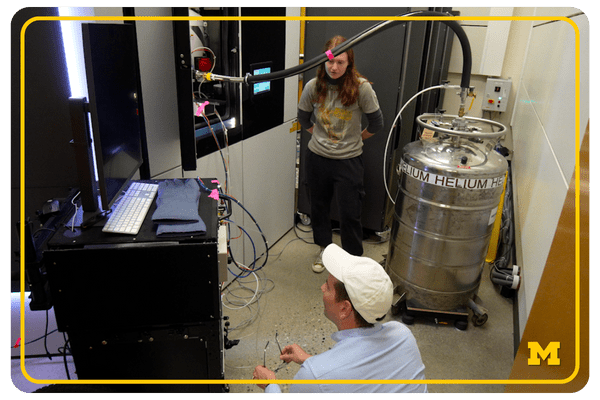 Researchers looking at the liquid helium cooling system at U-M's Center for Materials Characterization.