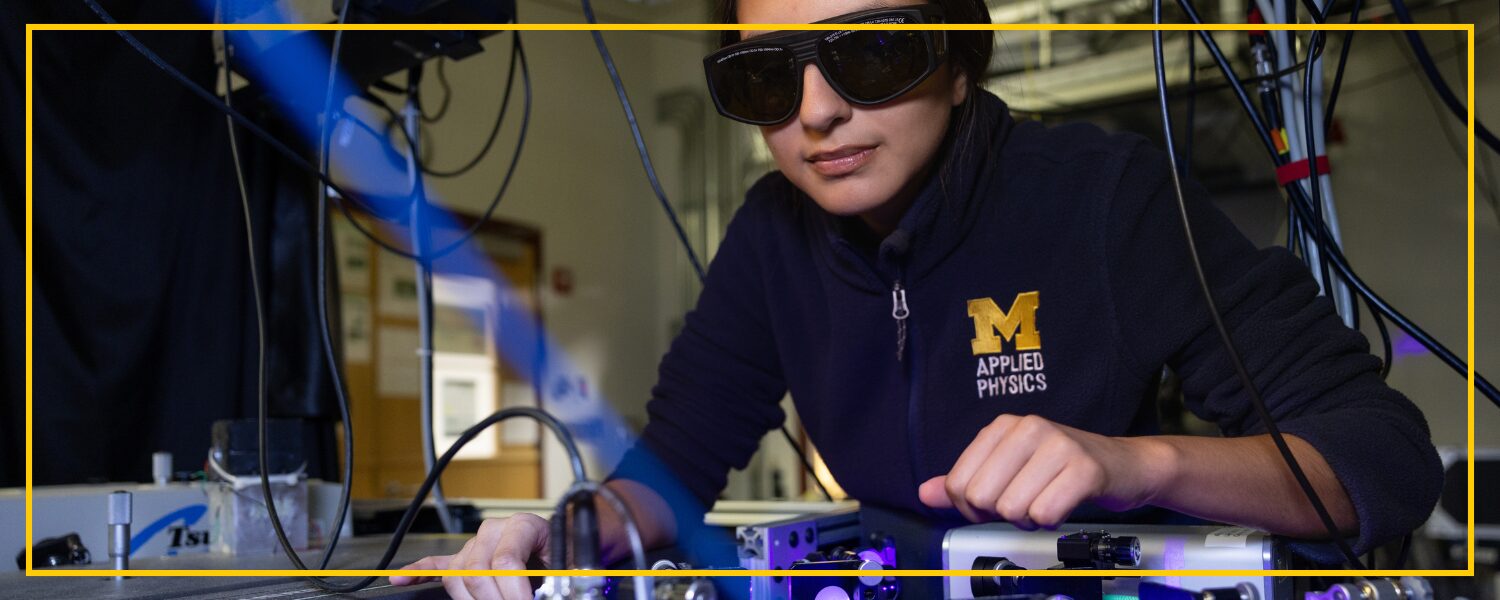photo of a student working on a electrical board, wearing protective, tinted eyewear