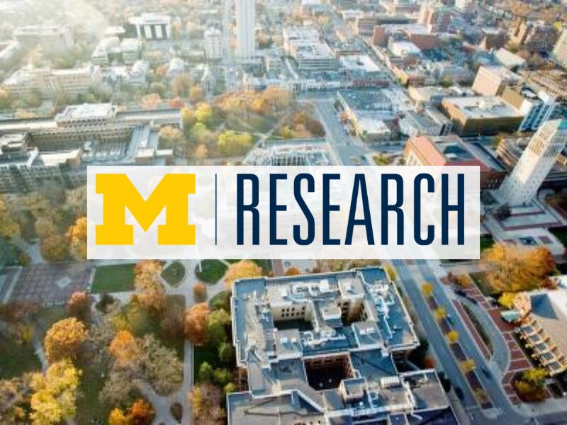 University of Michigan aerial campus view with “M Research” banner highlighting campus research and academic excellence.
