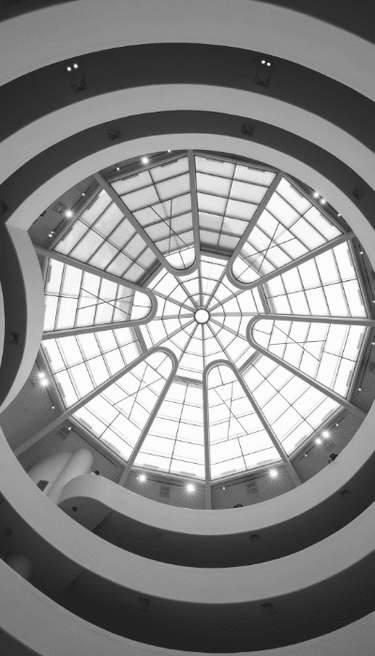 Looking up at the geometric glass skylight of the Guggenheim Museum in New York City