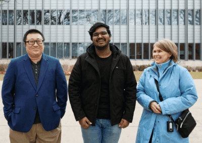 From left to right, Zheng Song, Shashank Chauhan and Natalia Czap, stand outside of a UM Dearborn building