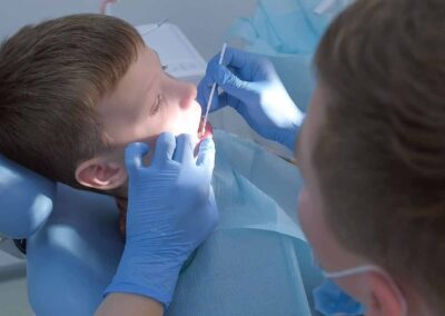 A dentist examining a child's teeth